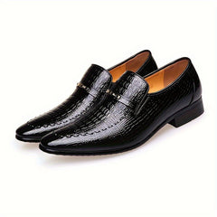 A pair of black crocodile-embossed men's slip-on loafers featuring a gold-tone metallic emblem.