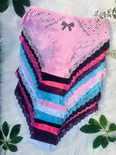 A stack of twelve colorful cotton briefs featuring contrast lace trim and a bow detail.