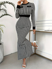 A woman wears a long-sleeved, bodycon houndstooth knit dress with a crew neck and button details.