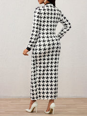 A woman wears a long-sleeved, black and white houndstooth maxi dress with a fitted silhouette.