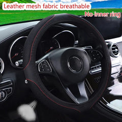 A black faux leather and mesh steering wheel cover with red stitching installed on a car wheel.