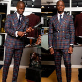 A man wears a double-breasted plaid suit with gold buttons, a white shirt, and a dark tie.