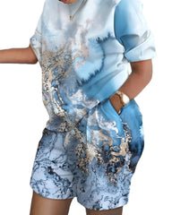 A woman wears a casual two-piece set featuring a blue and white marble print with pockets.