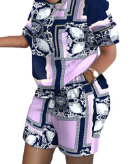 A woman wears a casual two-piece set featuring a short-sleeve shirt and shorts with a purple and navy blue gradient baroque print.