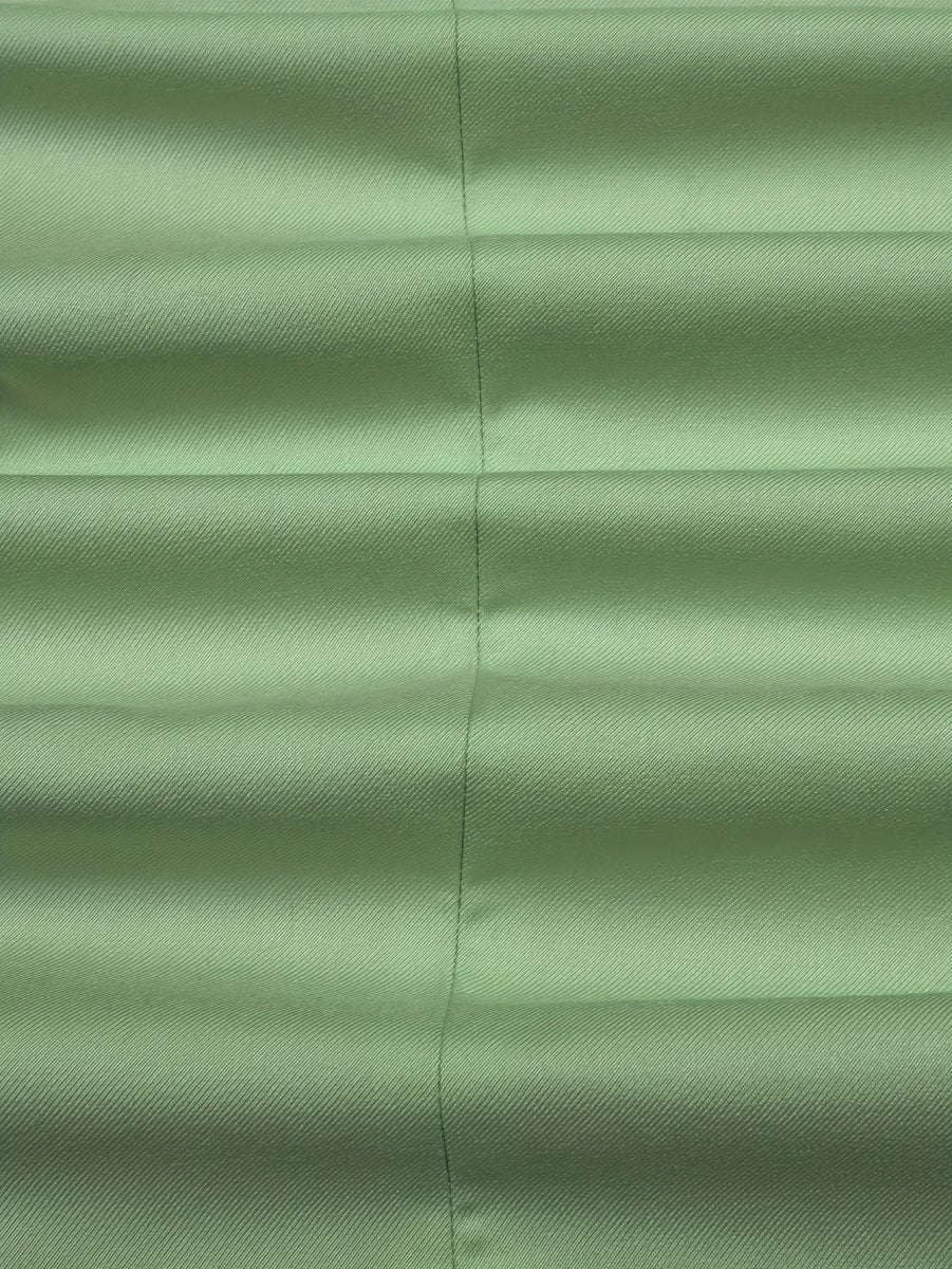A close-up view of a light green polyester suit jacket fabric with a subtle diagonal weave.