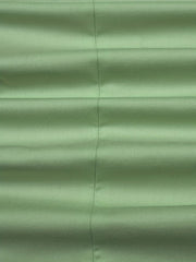 A close-up view of a light green polyester suit jacket fabric with a subtle diagonal weave.