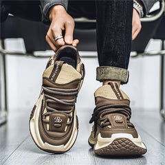 A pair of brown and beige chunky-soled casual sneakers with lace-up closures and a logo detail.