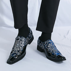 Men's slip-on shoes featuring a blue floral pattern with silver sequins and black patent toes.