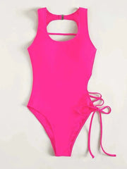 A bright pink one-piece swimsuit featuring a high neckline and a lace-up side detail.