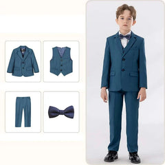 A boy wears a four-piece blue formal suit consisting of a jacket, vest, trousers, and bowtie.