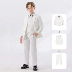 A boy wears a white four-piece formal suit consisting of a jacket, vest, shirt, and trousers.