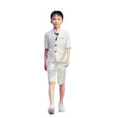 A boy wears a white short-sleeved suit jacket and matching shorts with a dark tie.