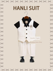 A children's British-style suit featuring a white vest, black shirt, and matching white trousers.