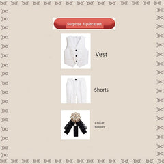 A three-piece children's suit set featuring a white vest, white shorts, and a black collar flower.