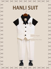 A children's British-style suit featuring a white vest, black shirt, and matching white trousers.