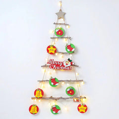 A DIY wooden ladder Christmas tree wall hanging decorated with ornaments and string lights.