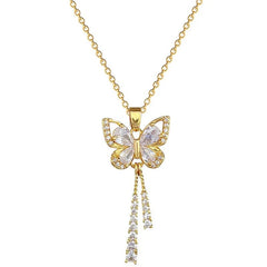A gold-tone butterfly pendant necklace featuring white crystal accents and two dangling tassel chains.