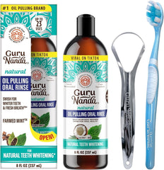 A bottle of GuruNanda coconut oil pulling rinse with a tongue scraper and toothbrush.