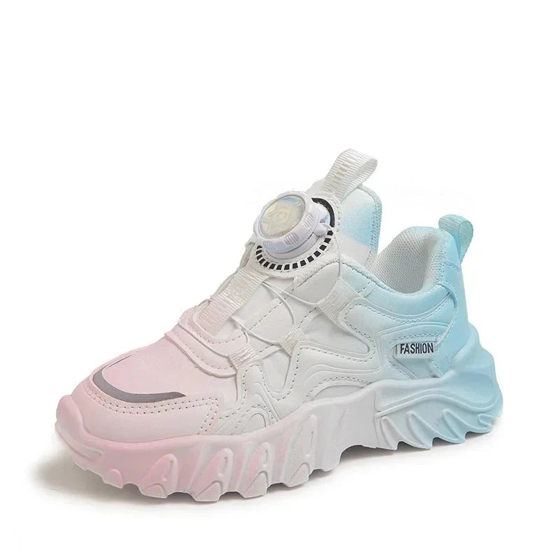 A children's sneaker with a pink to blue gradient mesh upper and a dial closure system.