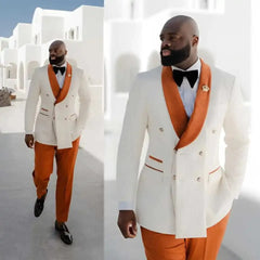 A man wears a white double-breasted blazer with an orange shawl lapel and matching orange pants.