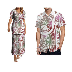 A woman wearing a Polynesian print dress and a man wearing a matching short-sleeve shirt.