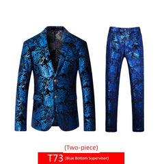 A two-piece suit featuring a blue blazer and matching trousers with a metallic floral print.