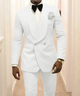 A man wears a white double-breasted two-piece suit with a shawl lapel and a black bow tie.