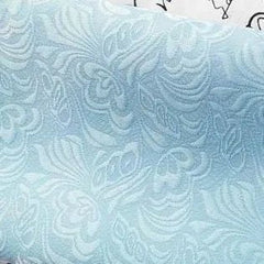 A close-up view of light blue fabric featuring a subtle, tone-on-tone floral damask pattern.