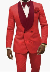 A man wears a red patterned two-piece tuxedo with a contrasting dark red shawl lapel and bow tie.
