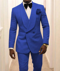 A man wears a vibrant blue two-piece tuxedo with a shawl lapel, white shirt, and black bow tie.