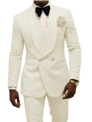 A man wears a white patterned two-piece tuxedo suit with a shawl lapel and a black bow tie.