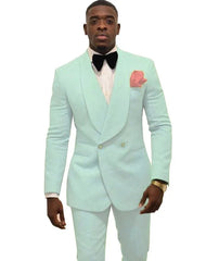 A man wears a light mint green double-breasted tuxedo with a shawl lapel and a black bow tie.