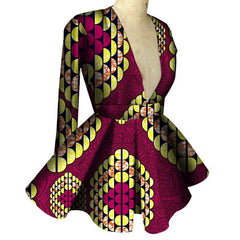 A long-sleeved, V-neck peplum top featuring a vibrant pink and yellow African-inspired print.