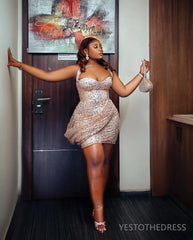 A woman wears a short, sequined, sweetheart-neckline cocktail dress with spaghetti straps.