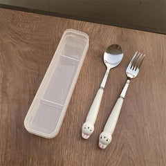 A stainless steel spoon and fork set with white rabbit-themed handles and a clear plastic case.