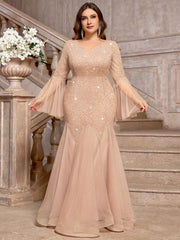 A plus-size champagne sequin lace mermaid gown with a V-neck and sheer bell sleeves.