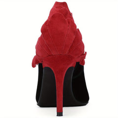 A rear view of a black stiletto pump featuring a red suede floral-shaped heel detail.