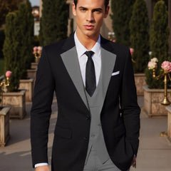 A man wears a black suit jacket with grey lapels, a matching grey vest, and a white dress shirt.