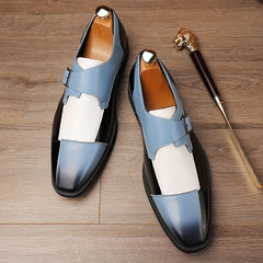 A pair of men's blue, white, and black square-toe dress shoes with buckle closures.