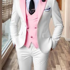 A slim-fit three-piece suit featuring a white jacket and trousers with a contrasting pink vest.