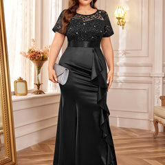 A plus size black mermaid dress with a sequined lace bodice, short sleeves, and ruffled side.