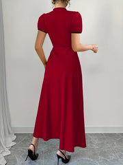 A woman wears a solid red midi dress with short sleeves and a high neckline from the back view.