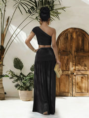 One-shoulder top and ruched maxi skirt set by Trendsi, featuring a stylish, coordinated ensemble in soft fabric.