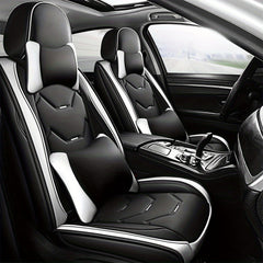 Black and white faux leather car seat covers with matching headrest and lumbar pillows.