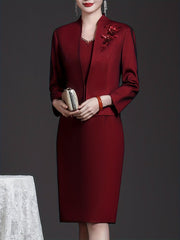 A woman wears an elegant wine red two-piece dress set with an embroidered long-sleeve coat.