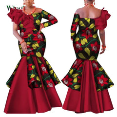 A woman models a floral print African-style mermaid dress with a red ruffled one-shoulder detail.