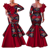 A woman models a red and patterned one-shoulder African-style mermaid dress with a ruffled sleeve.