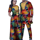 A man and woman wearing matching outfits with a colorful, curved-line pattern and gold accents.