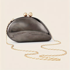 A dark marbled acrylic clutch with a gold magnetic closure and a detachable gold chain strap.