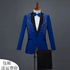 A royal blue performance blazer with a black shawl collar and intricate rhinestone embellishments, paired with black trousers.